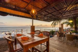 a table on the beach with a view of the ocean at Amed Beach Resort in Amed