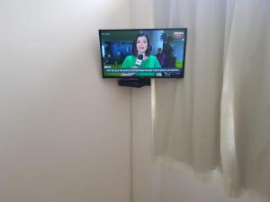 a television on a wall in a room at Estadia Confortável AP 102 in Juiz de Fora
