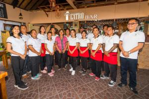 a group of people standing in a store with a red ribbon at Amed Beach Resort in Amed