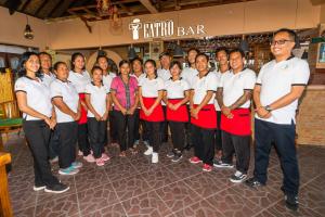 a group of people posing for a picture in a store at Amed Beach Resort in Amed
