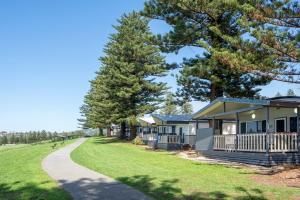 a row of cottages at the end of a road at Surf Beach Holiday Park in Kiama