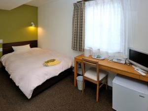 Postel nebo postele na pokoji v ubytování Kumagaya Royal Hotel Suzuki