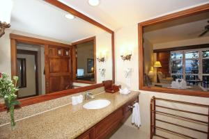 a bathroom with a sink and a large mirror at Novela Muine Resort & Spa in Mui Ne