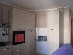 a room with a kitchen with a large cupboard at Universal Apartments Itri C in Itri