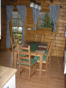 a dining room with a wooden table and chairs at Drevenica pod smrekom in Terchová