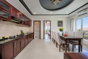 a kitchen and dining room with a table and chairs at Gio Bien 2 Hotel by THG in Danang