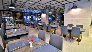 a dining room with tables and chairs and tablesktop at Ramira Joy Hotel in Alanya