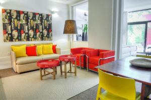 a living room with colorful chairs and a table at Three Houses & Bedrooms in Porto