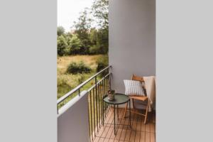 a balcony with a table and a view of a field at Piastowska sleeping - mieszkanie w centrum miasta in Krosno