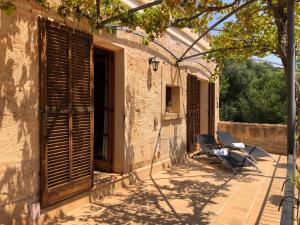a chair sitting on a patio next to a building at Agroturisme Son Samà in Llucmajor