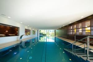 a pool in a building with a swimming pool at Hotel Sonnenhof in Lautenbach