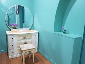 a dressing table with a mirror and a stool at Jeju Vision House in Jeju
