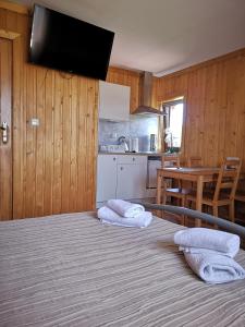 a bedroom with a bed with two towels on it at Ustup 25 in Zakopane