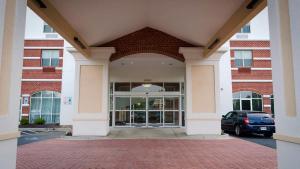 an entrance to a building with a car parked in front at Holiday Inn Express La Plata, an IHG Hotel in La Plata
