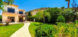 a house with a garden in front of it at Holidays Villas in Pissouri