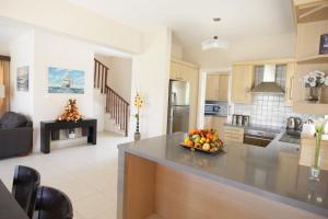 a kitchen with a bowl of fruit on a counter at Holidays Villas in Pissouri