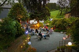 a group of people sitting in chairs in a garden at Die Sperre in Winterberg