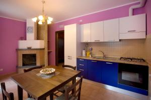 a kitchen with a table and a dining room at Agriturismo il Girasole in Montefalco