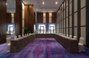 a large meeting room with a long table with chairs at Golden Palm Tree Sepang in Sepang