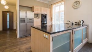 a kitchen with a refrigerator and a counter top at Grand Lehe Beach Apartment in Pärnu