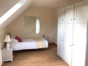 a bedroom with a bed and a mirror at Cael Uisce apartment 31 Cliff road in Belleek