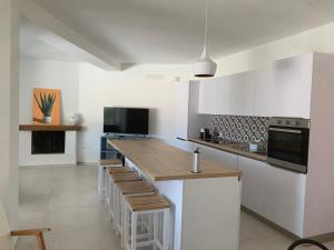 a kitchen with a large island with a counter top at Bona Ciurrata in Golfo Aranci
