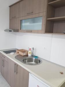 a kitchen with a sink and a white counter top at Apartman Nikolic in Veliko Gradište