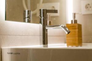 a bathroom sink with a faucet and a mirror at ATSEDEN apartment aire condicionado - Opción a parking - in San Sebastián +31 photos