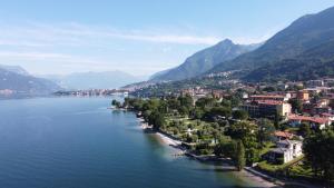 a town on the shore of a lake with mountains at Park Hotel Abbadia in Abbadia Lariana