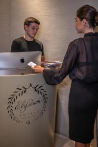 a woman standing next to a man with a laptop at Elysium Suites collection in Rome