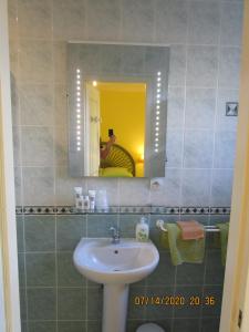 a bathroom with a sink and a mirror at Locatlantique in Aytré