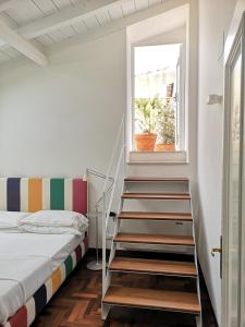 מיטה או מיטות בחדר ב-L'Approdo delle Sirene