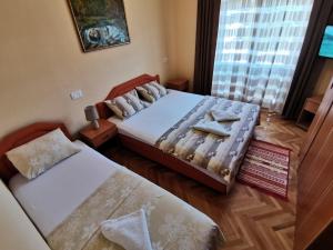 a bedroom with two beds and a window at Apartments Abramovic in Sutomore