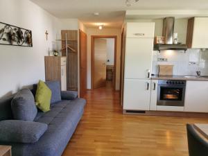a living room with a couch and a kitchen at Haus Sophia in Tschagguns