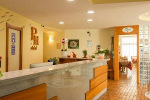a lobby with a reception counter and a dining room at Park Hotel Abbadia in Abbadia Lariana