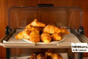 a plate of croissants sitting on a shelf at Park Hotel Abbadia in Abbadia Lariana