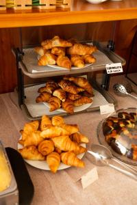 three trays of food on plates on a table at Park Hotel Abbadia in Abbadia Lariana
