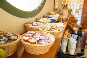 a counter with baskets of pastries on a table at Park Hotel Abbadia in Abbadia Lariana
