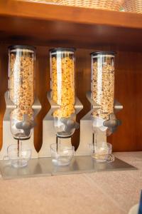 a group of three glass containers filled with cereal at Park Hotel Abbadia in Abbadia Lariana