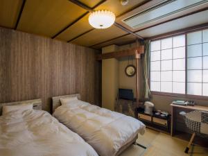 Uma cama ou camas num quarto em Kaigetsu