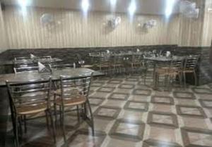 The Park Residency في نويدا الكبرى: غرفة طعام مع طاولات وكراسي في مطعم