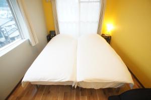 Letto o letti in una camera di Plusone Nishikoen