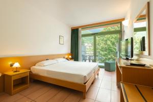 een hotelkamer met een bed en een televisie bij Park Hotel Abbadia in Abbadia Lariana +37 foto's