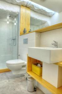 a bathroom with a sink and a toilet and a shower at Three Houses & Bedrooms in Porto