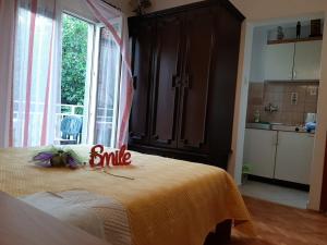 a bedroom with a bed with a smile sign on it at City centre in Stari Grad +1 photo