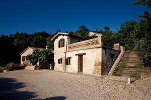 a stone house with stairs on the side of it at Agriturismo il Girasole in Montefalco