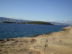 a large body of water with mountains in the background at Villa Welcome in Vrboska