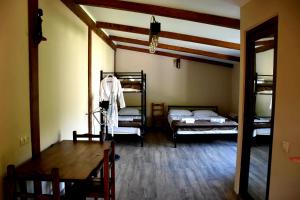 a room with two bunk beds and a table at Guest House Metreveli in Borjomi