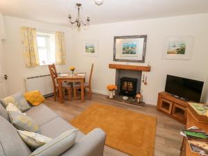 a living room with a couch and a fireplace at Garnedd in Holyhead