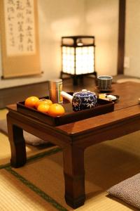 a tray of oranges on a wooden table at Gion House in Kyoto